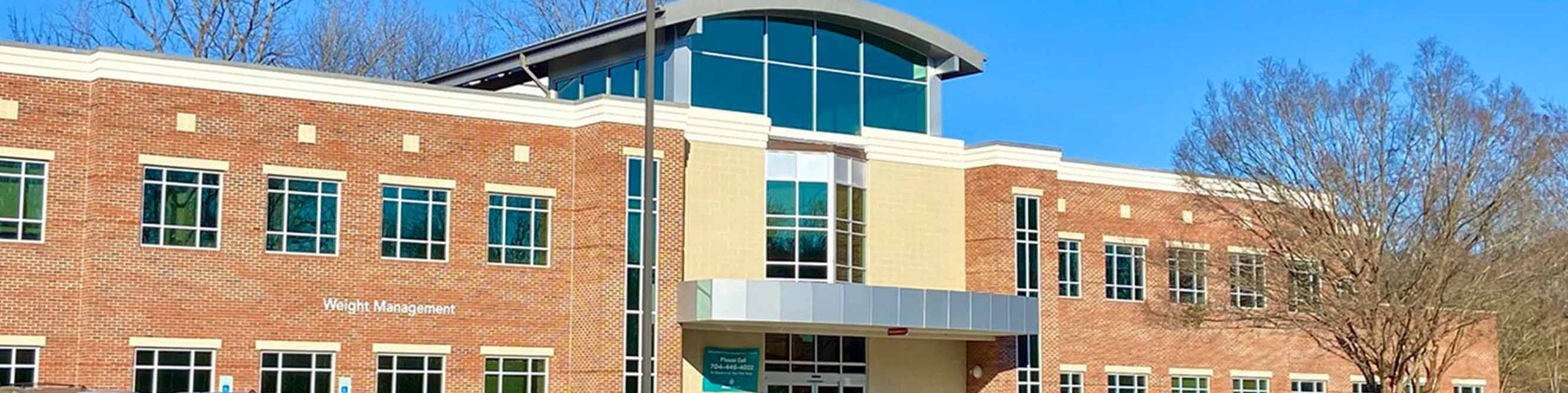 Exterior of the Eastover Medical Park dermatology office, located between Randolph and Monroe Roads with beautiful surroundings.