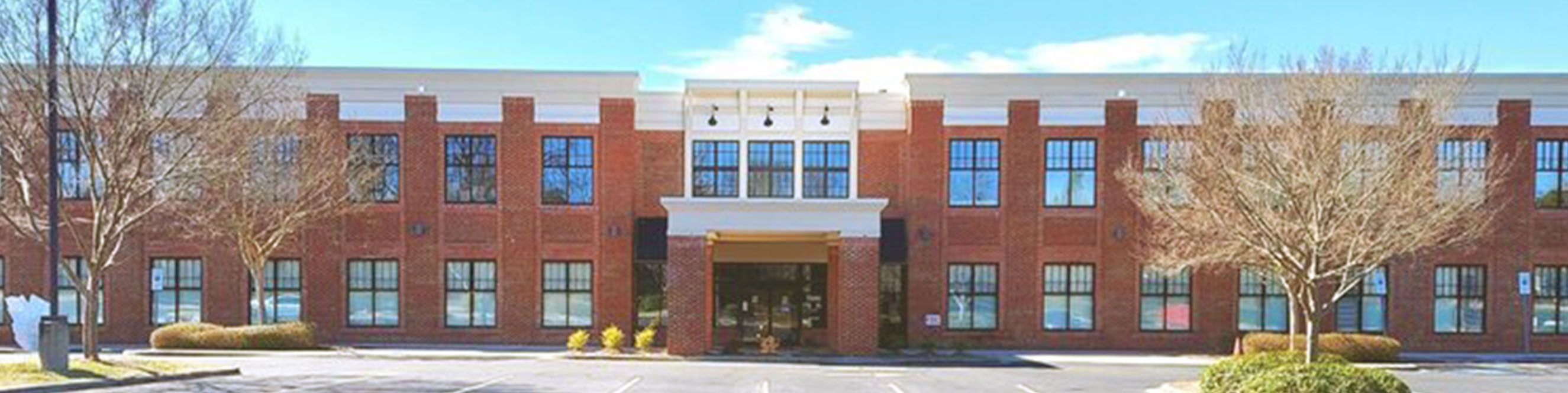 Exterior view of the Cornelius dermatology office in a business park near Lake Norman with easy access and parking.