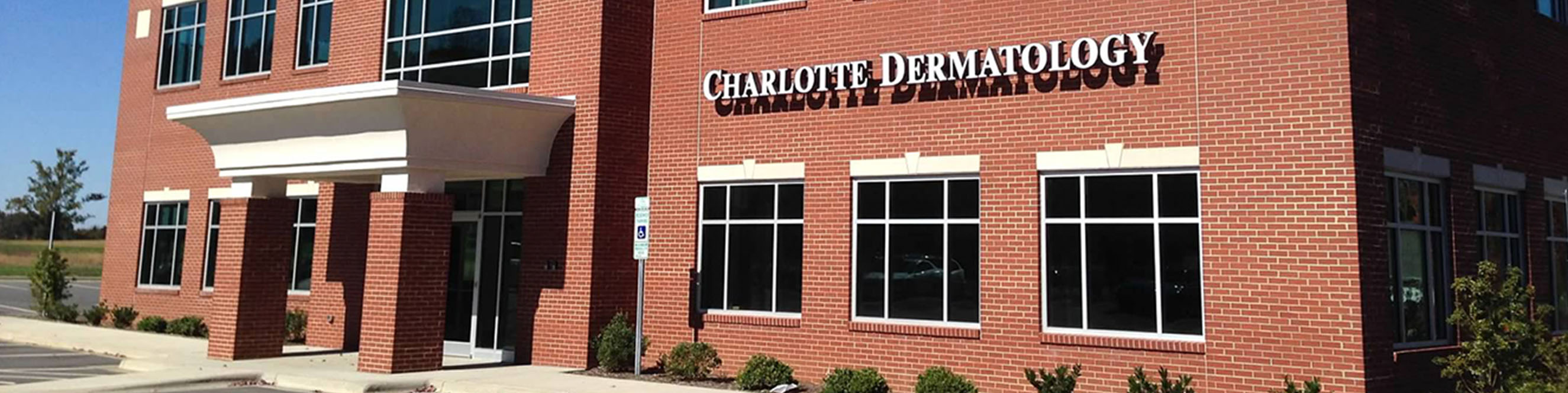 Exterior view of the Rocky River dermatology office, near I-485 and the CMC Emergency HealthPlex with parking available.